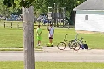 Boys Hop Off their Bikes to Pay Respects during Veteran’s Funeral